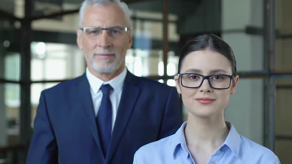 Male Ceo With Female Secretary Looking on Camera, Insurance Agency Advertising