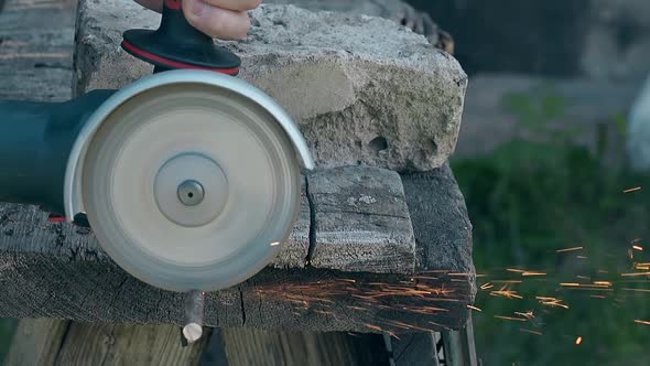 Close View Circular Saw Cuts Piece of Metal Rod on Table