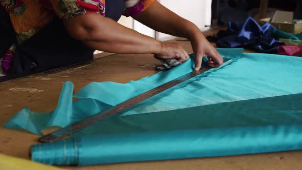 Mixed race woman working at a hat factory