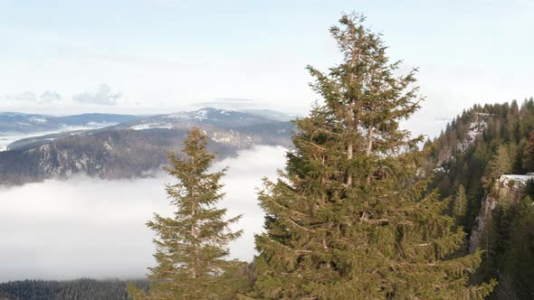 Aerial dolly of beautiful mountaintops above the clouds