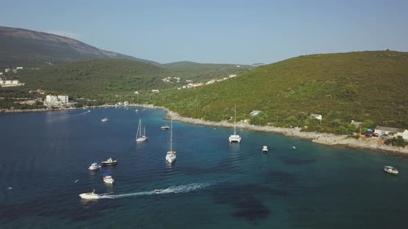 Aerial view of group of Yachts cruising on the sea or ocean in summer day in Montenegro.