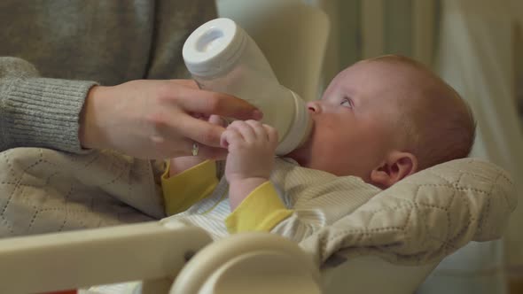 Baby Eats From A Bottle