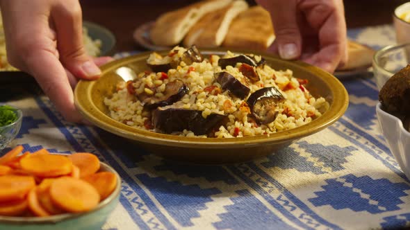 Putting Bulgur with Eggplant Closeup Couscous with Meat on Background