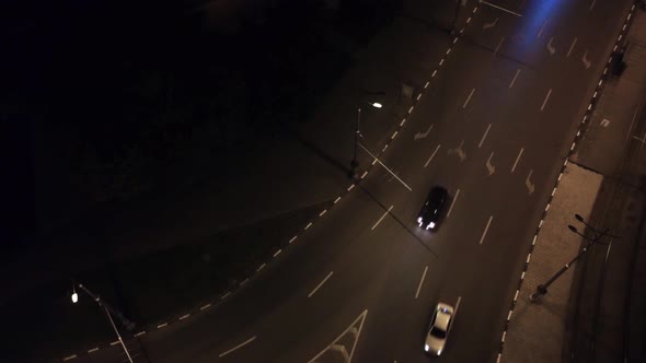 City streets aerial look down, cars on night road