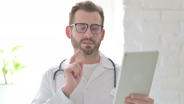 Portrait of Video Call on Tablet By Doctor in Office