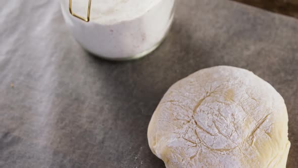 Dough ball pressed on butter paper