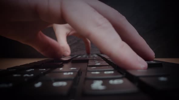 Man Hands Type on Keyboard with White Signs in Office