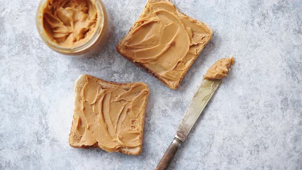 Two Tasty Peanut Butter Toasts Placed on Stone Table