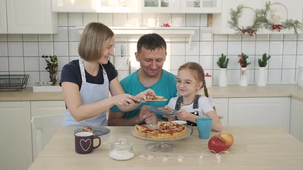 Mother Putting Pieces of Apple Pie for Breakfast