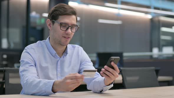 Young Man Making Unsuccessful Online Payment on Smartphone