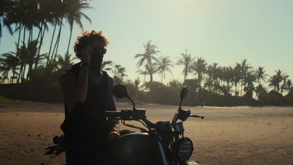 Traveller is Sitting on Bike on Tropical Beach