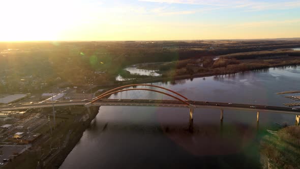 Dramatic aerial approach towards Hastings Bridge over Mississippi River, on a bright evening