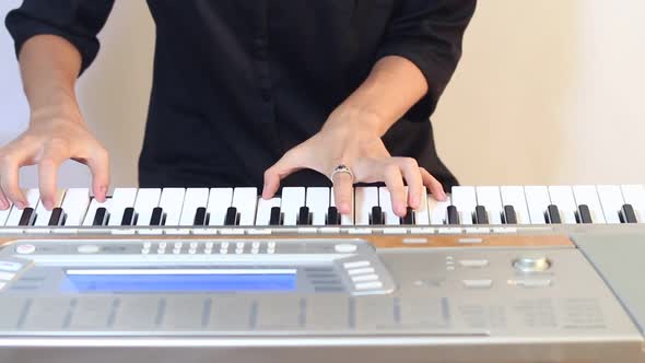 Female Musician Playing The Synthesizer