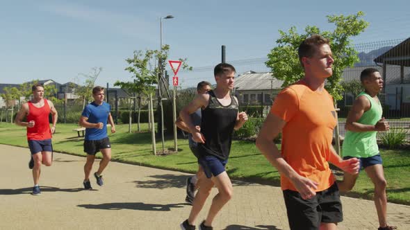 Men running outside on sunny day