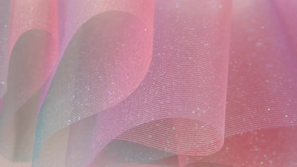 Fabric background.Tulle fabric.Shiny pink fabric with gradients.