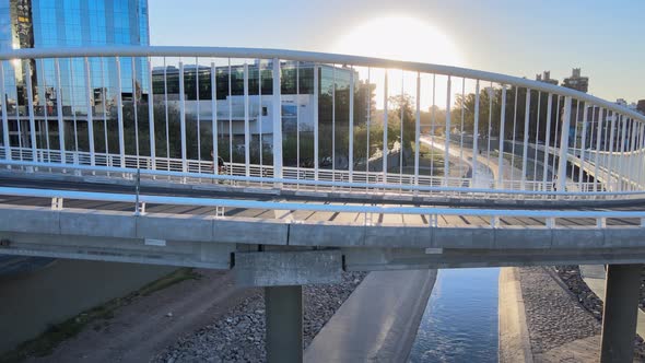 Cinematic slow pull out shot away from the new curved ramon mestre bridge in downtown Cordoba city i