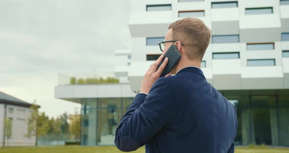 The Businessman Is Going and Talking Emotionally on the Phone