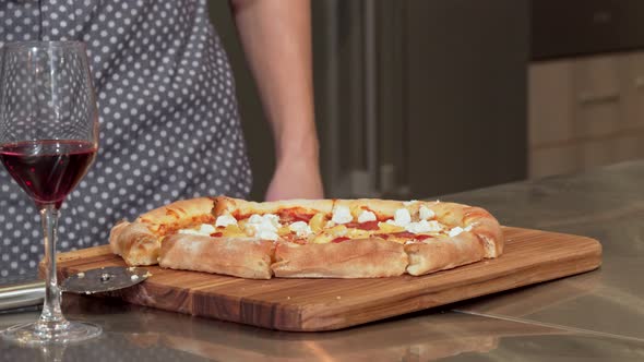 Man Grabbing Piece of Delicious Pizza From the Table