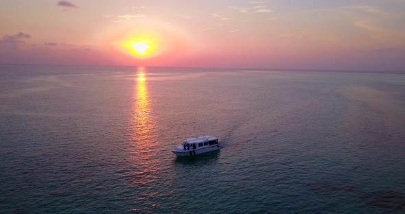 Daytime birds eye travel shot of a sunshine white sandy paradise beach and blue ocean background in 