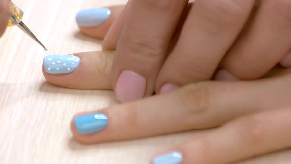 Manicurist Drawing Snow on Client Nails.