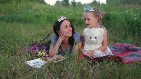 Little Girl with Mom Chatting While Reading Book