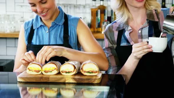 Two beautiful waitress working behind the counter