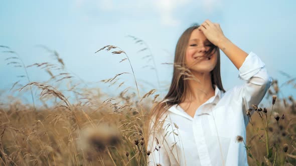 Young Beautiful Woman Posing in a Golden Field