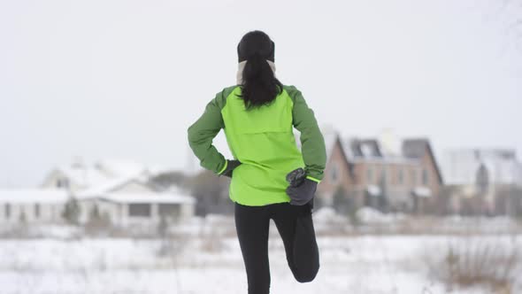 Unrecognizable Woman Stretching before Jog in Winter