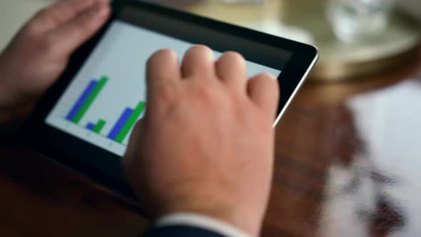 Entrepreneur Hands Using Tablet Check Finance Graphics on Business Trip Closeup