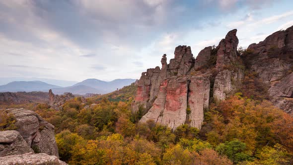 Moving clouds at autumn picturesque rock formation