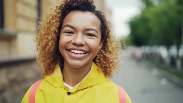 Close-up Slow Motion Portrait of Good-looking African American Woman Looking at Camera with Glad