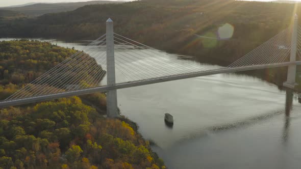 Autumn sunset at the Penobscot Narrows Bridge with lens flare AERIAL ORBIT