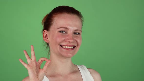 Attractive Happy Red Haired Woman Showing Ok Sign