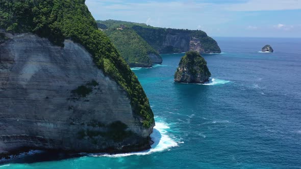  Kelingking beach, Nusa Penida, Bali, Indonesia. Aerial view at sea and rocks.