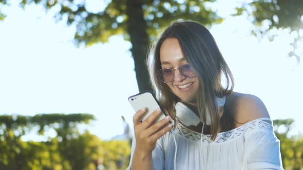 Girl Sharing Photograph on Social Media with Mobile Phone 