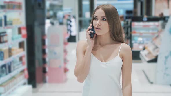 Sociable Beautiful Young Caucasian Woman Communicates on Smartphone 