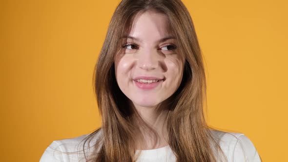 Portrait of happy young woman smiling shyly