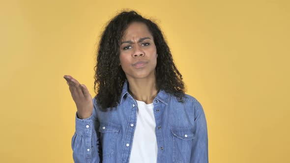African Girl with Frustration and Anger Isolated on Yellow Background
