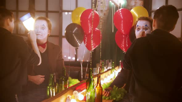 Make-up Artist Applying Face Paint on the Man Clown in the Dressing Room