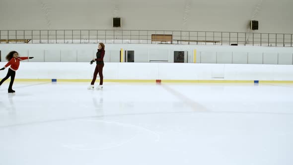 Female Coach Working with Little Figure Skater