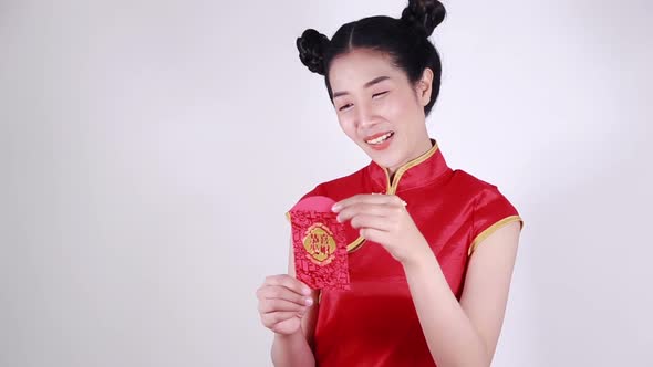 woman wear cheongsam and open red envelope in concept of happy chinese new year