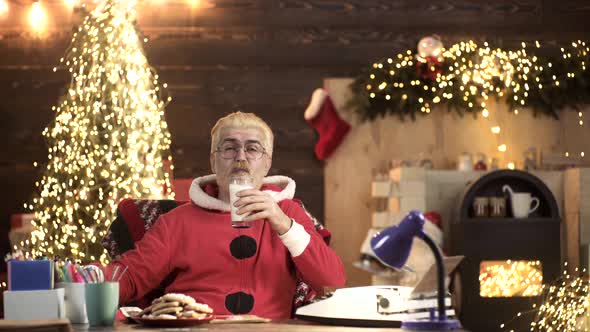 Portrait of Santa Claus with Gifts at Home Near Christmas Tree. New Year Holiday.