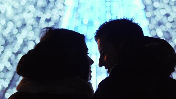 Close-up of a Couple Looking at the European New Year Tree of the City, the Lights From the Garland