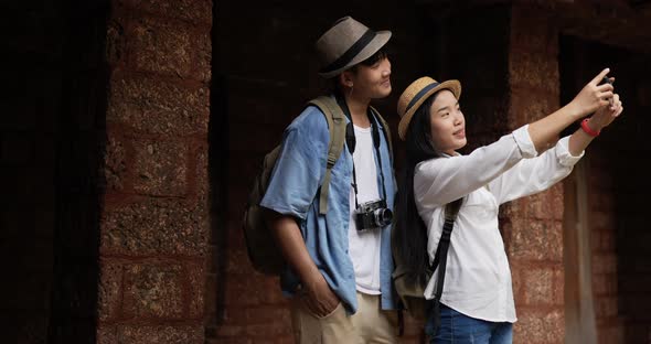 Couple selfie on smartphone in ancient temple