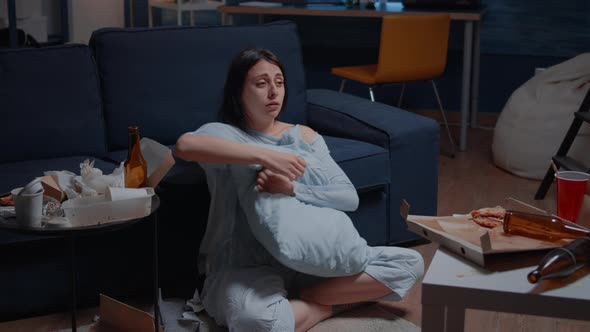 Stressed Depressed Woman Crying Sitting in Dirty Room