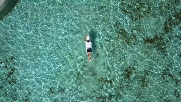 Young man is practicing surfing and swimming