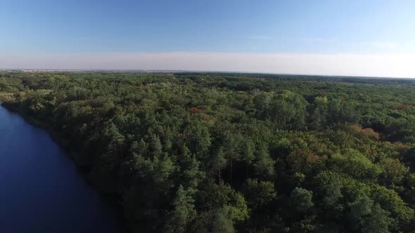 Aerial View. Flying Over the River and Green Forest