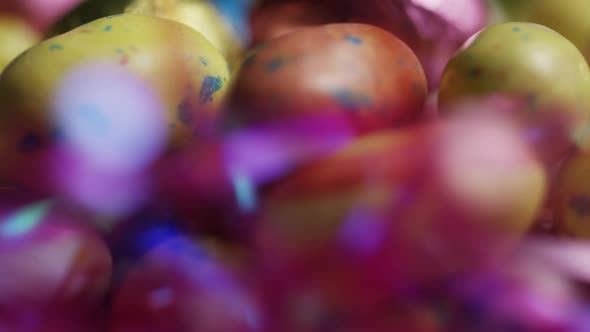 Rotating shot of colorful Easter candies on a bed of easter grass