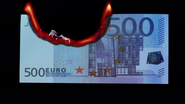 Burning of 500 Euro Banknote on Black Bacground Closeup