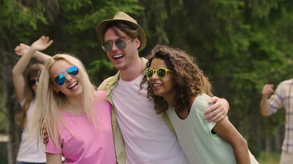 Slow Motion of Happy Young People Hugging, Laughing and Dancing at Outdoor Party